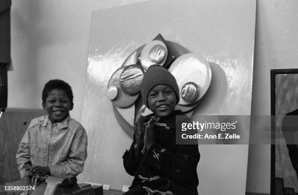 View of two children smiling as they attend the opening event for the Art Contest Exhibition at the Art & Soul community art center , in the Lawndale...