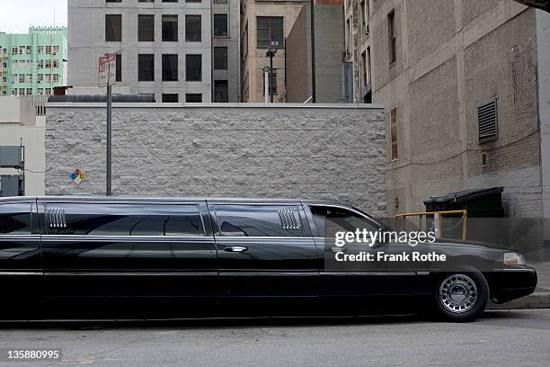 a stretch limo parks downtown - limousine bildbanksfoton och bilder