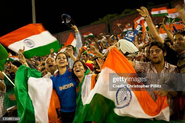 Pakistan vs India in the 2011 Cricket World Cup semi final match in Mohali, India. Fans celebrate this rare moment of two giants of the game.