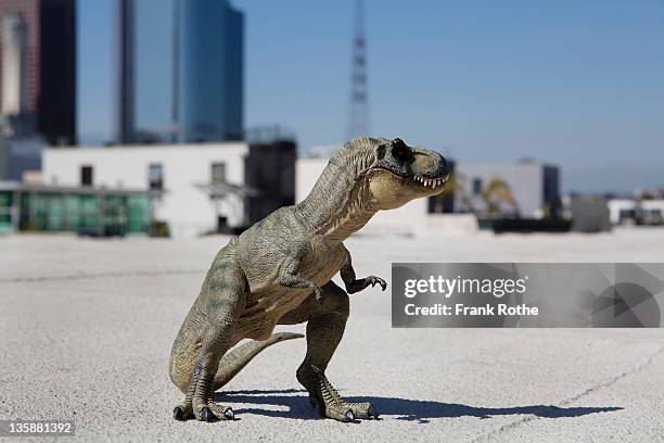 tyrannosaurus rex made from rubber stand in city - t rex stock-fotos und bilder