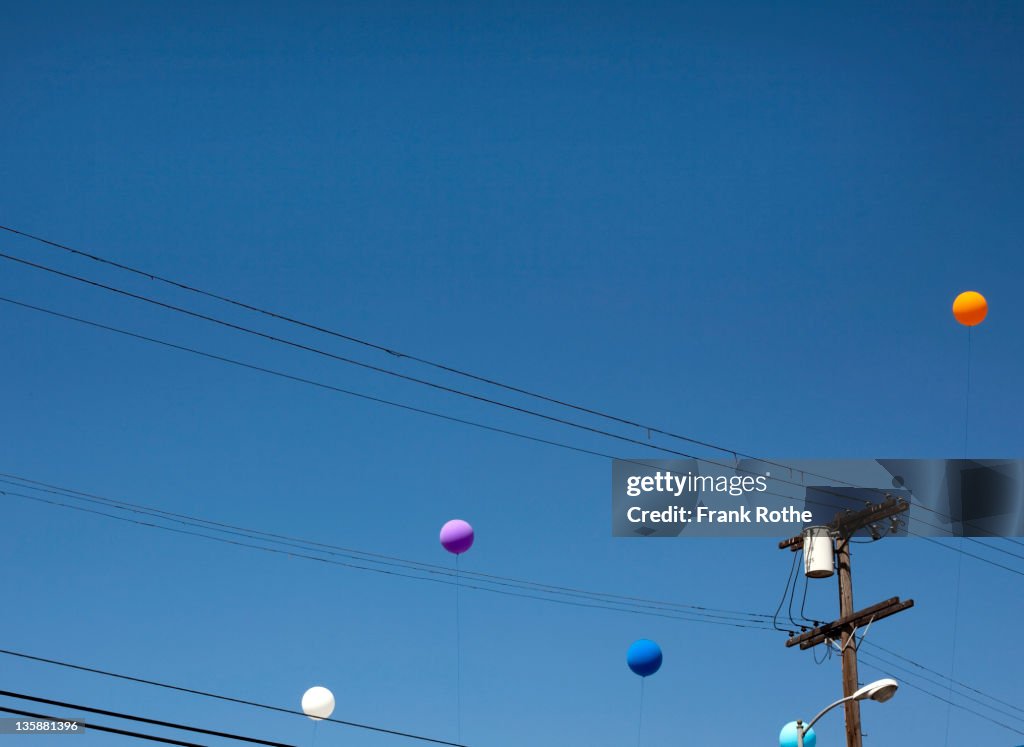 Colourfull balloons flying into the blue sky