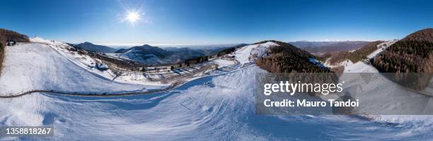 aerial view during a beautiful winter day in the orobie alps, mountains of san fermo, bergamo province, italy - mauro tandoi fotografías e imágenes de stock