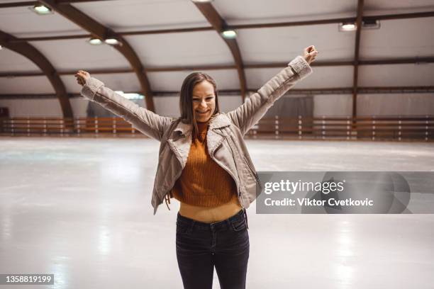 beautiful woman ice skating in the ice rink - figure skating woman stock pictures, royalty-free photos & images