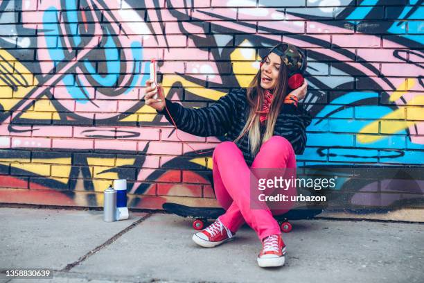 young woman taking a selfie by the street art - music graffiti stock pictures, royalty-free photos & images