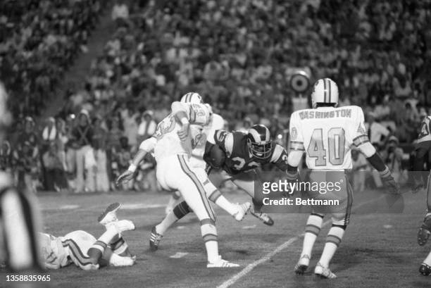 Rams' Cullen Bryant steps over Tampa Bay's Ted Jornov after taking a pass form James Harris for an eight yard gain to Tampa's 33 yard line during...