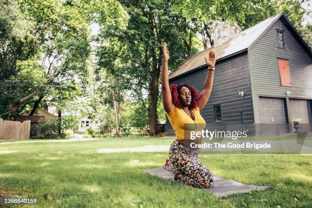 young woman practicing yoga in backyard - showus ストックフォトと画像