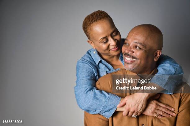 studio portrait of middle aged african american couple - couple studio shot stock pictures, royalty-free photos & images