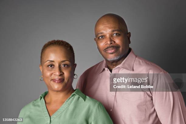 studio portrait of middle aged african american couple - studio portrait stock pictures, royalty-free photos & images