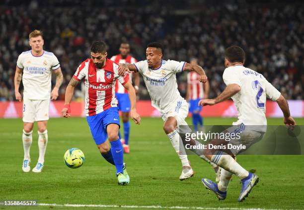 Luis Suarez of Atletico de Madrid is challenged by Eder Militao of Real Madrid during the La Liga Santander match between Real Madrid CF and Club...