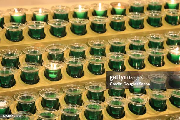 green votive candles in a shrine - 覚悟 ストックフォトと画像