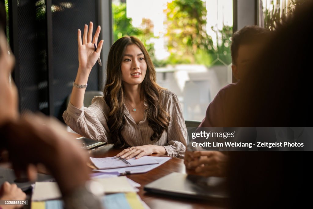 Business lady asking a question during a discussion