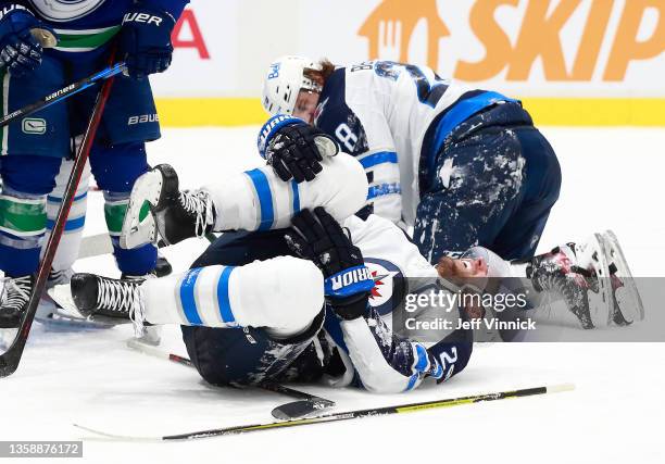 Blake Wheeler of the Winnipeg Jets winces in pain after straining his knee during their NHL game against the Vancouver Canucks at Rogers Arena...