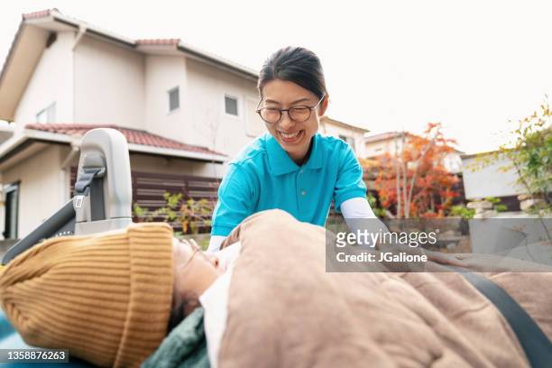 female carer talking with an elderly patient - essential services stock pictures, royalty-free photos & images