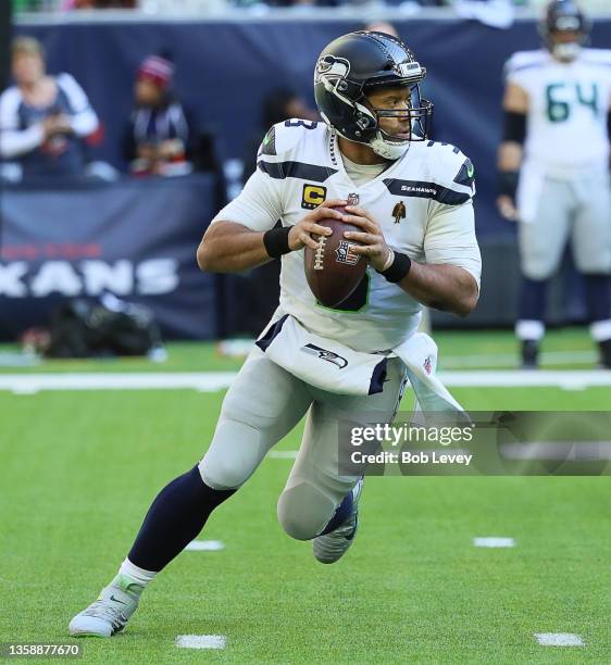 Seattle Seahawks quarterback Russell Wilson runs with the ball against the Houston Texans at NRG Stadium on December 12, 2021 in Houston, Texas.