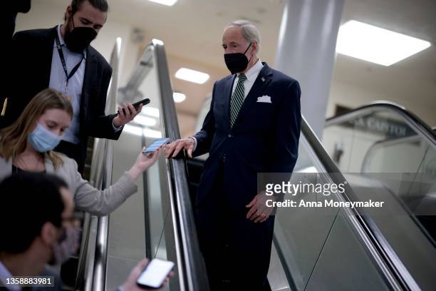 Sen. Tom Caper speaks with reporters as he walks through the Senate Subway of the U.S. Capitol Building on December 13, 2021 in Washington, DC. The...