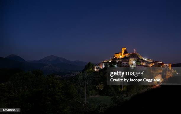 mountain city in the night - jacopo caggiano stockfoto's en -beelden