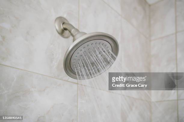 water flows from shower head - shower head stock pictures, royalty-free photos & images