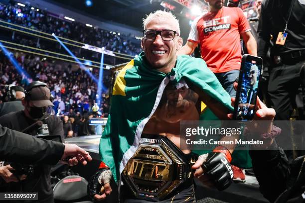 Charles Oliveira of Brazil celebrates after defeating Dustin Poirier to defend his lightweight title during the UFC 269 event at T-Mobile Arena on...