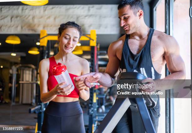 exercising with assistance of personal trainer - protein drink stock pictures, royalty-free photos & images