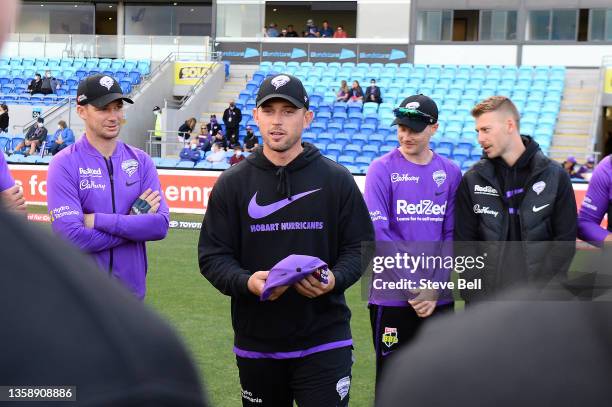 Ben McDermott of the Hurricanes presents Harry Brook of the Hurricanes with his first cap during the Men's Big Bash League match between the Hobart...