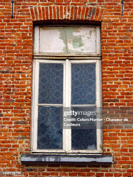 weathered window and brick house facade in brussels - fönsterram bildbanksfoton och bilder