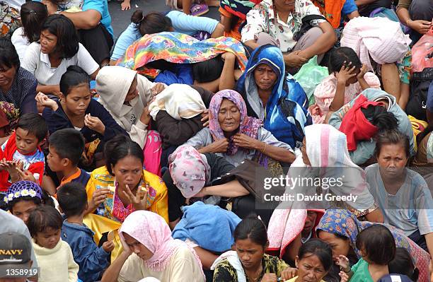 Approximately 1,500 Filipino deportees from Malaysia wait to disembark a navy ship August 29, 2002 in Bongao which is located in the southern...