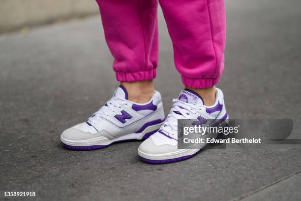 Katie Giorgadze @katie.one wears neon pink recycled cotton sport pants / jogger pants, white leather and purple details 550 sneakers from New...