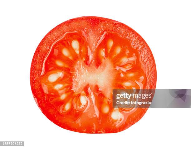 half sliced tomato on white background. sharp focus - knob stock pictures, royalty-free photos & images