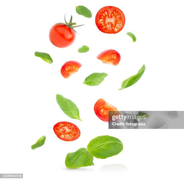 fresh tomatoes and basil leaves levitating - tomat bildbanksfoton och bilder