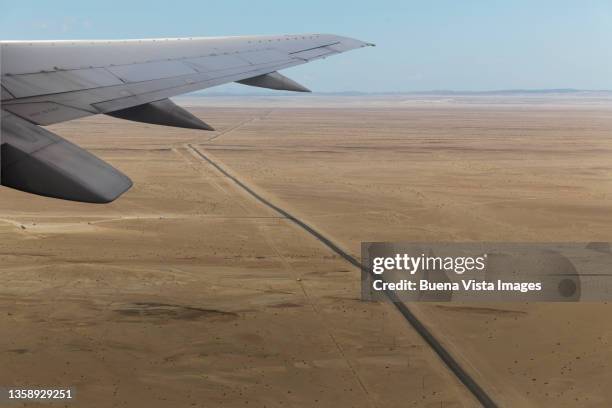 airplane flying over a desert. - namibia airplane stock pictures, royalty-free photos & images