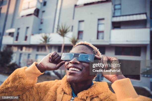 teenage girl looking at solar eclipse - teenager awe stock pictures, royalty-free photos & images