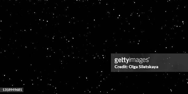black textured background. white particles on black. - star field fotografías e imágenes de stock