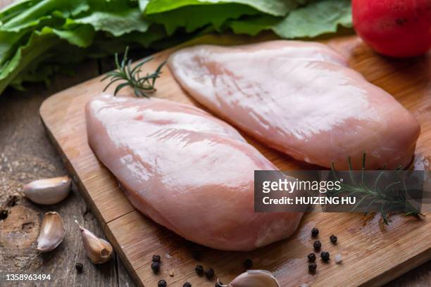 raw chicken breast fillet with rosemary and spices on a wooden background - chicken meat fotografías e imágenes de stock