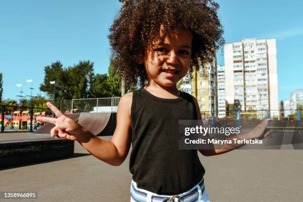 happy afro girl on a walk in the city. - windmill girls stock pictures, royalty-free photos & images