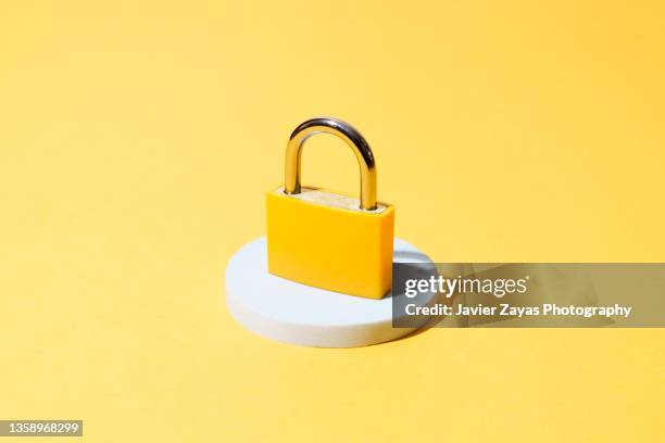yellow padlock on yellow background - password strength stock pictures, royalty-free photos & images