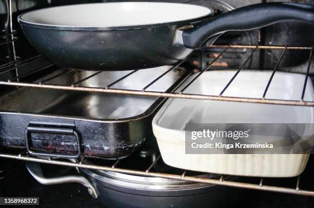 frying pans in the oven - dirty oven stock pictures, royalty-free photos & images