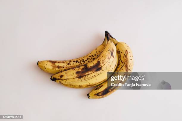 old bananas with mold on beige background - ripe stock pictures, royalty-free photos & images