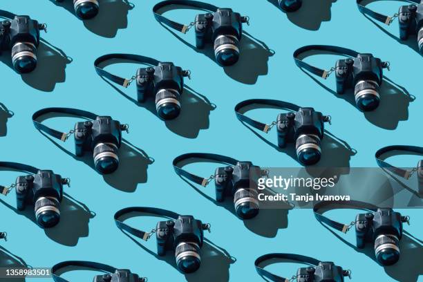 pattern of cameras on blue background - digital single lens reflex camera stock pictures, royalty-free photos & images