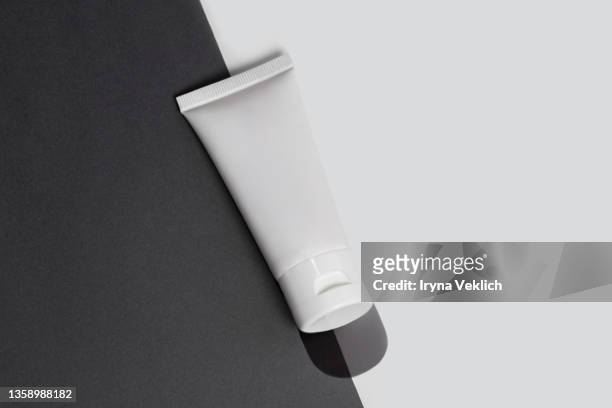 white color tube of organic  moisturizing facial cream  or hand cream, suntan lotion on grey and white color background. routine step for healthy skin care. - cream tube stock pictures, royalty-free photos & images