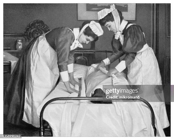 old engraved illustration of changing the under sheet in the case of a helpless patient - patience illustration stock pictures, royalty-free photos & images