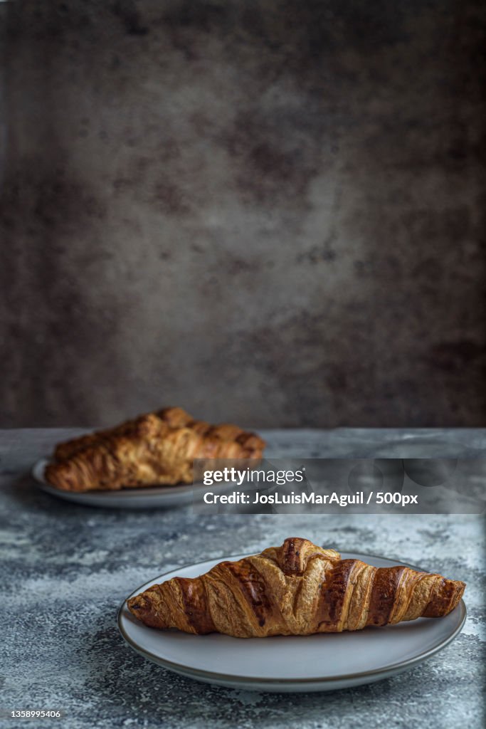 Close-up of croissants in plate on table