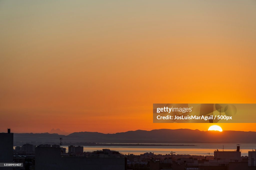Amanecer desde casa,Scenic view of sea against orange sky,Spain