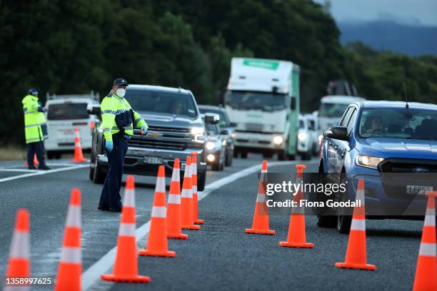 Police check northbound travellers' vaccination passes or negative covid tests at the Northland checkpoint at Uretiti on SH1 on December 15, 2021 in...
