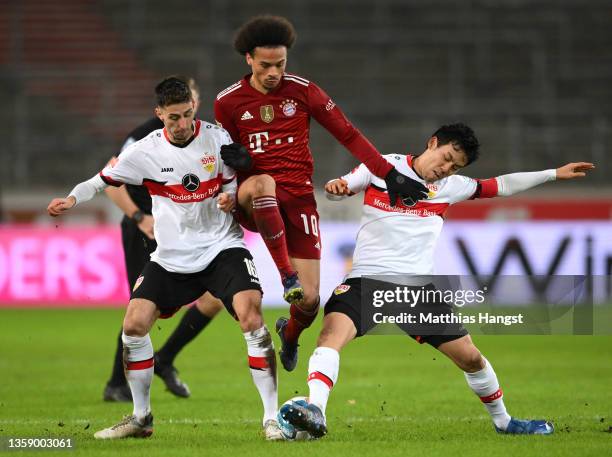 Leroy Sane of FC Bayern Muenchen is challenged by Atakan Karazor and Wataru Endo of VfB Stuttgart during the Bundesliga match between VfB Stuttgart...