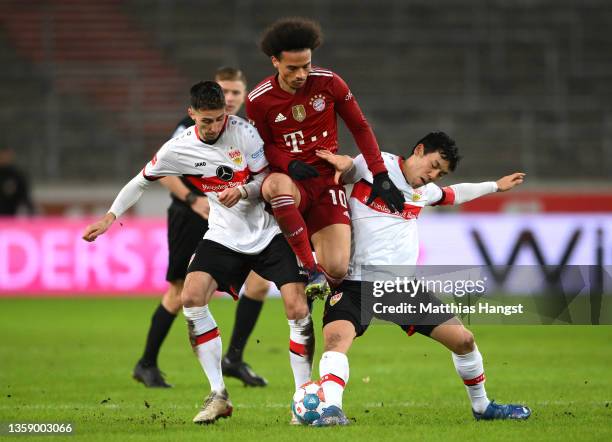 Leroy Sane of FC Bayern Muenchen is challenged by Atakan Karazor and Wataru Endo of VfB Stuttgart during the Bundesliga match between VfB Stuttgart...
