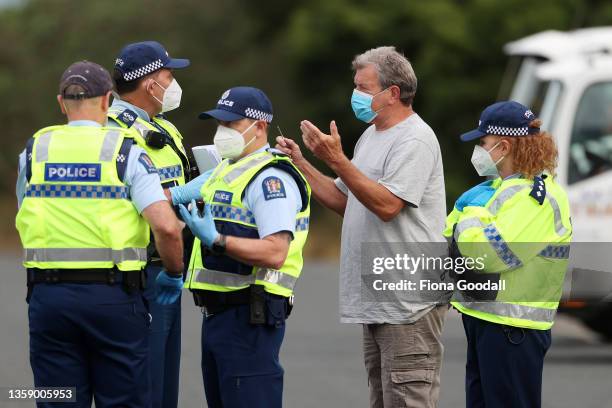 Traveller talks with police as they check north bound travellers vaccination passes or negative covid tests at the Northland checkpoint at Uretiti on...