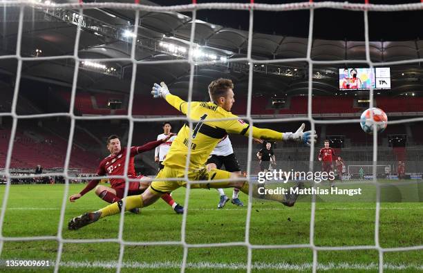 Robert Lewandowski of FC Bayern Muenchen scores their side's fourth goal past Florian Mueller of VfB Stuttgart during the Bundesliga match between...