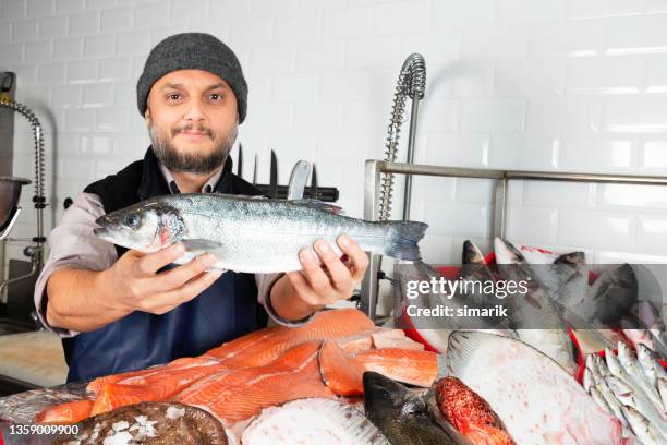 man selling fish - fishmonger stock pictures, royalty-free photos & images
