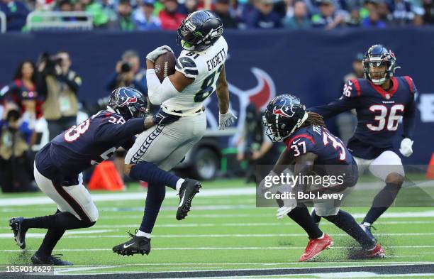 Seattle Seahawks tight end Gerald Everett catches a pass as Houston Texans middle linebacker Christian Kirksey and cornerback Tavierre Thomas make...