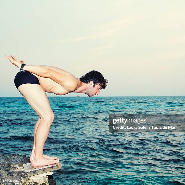 man diving in sea - shorts down stock pictures, royalty-free photos & images